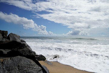 coastline of mahabalipuram seashore with constantly hitting sea waves on the rocky stones. scenic vi