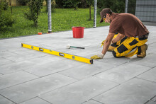 Worker Building Patio Concrete Tiles Floor