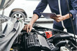© A Stockphoto - Automobile mechanic repairman hands repairing a car engine automotive workshop with a wrench, car service and maintenance,Repair service.