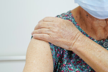 Wall Mural - Asian elder senior woman patient getting coronavirus vaccine.