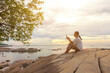 © Nitiphonphat - Asian women take photos and video calls at sea and beach in the morning at sunrise with their mobile phones, smartphones for posting to the internet online while traveling on vacation.
