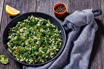 Canvas Print - Spanakorizo, Greek spinach and rice pilaf in pan