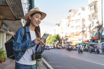 Backpacker journey destination concept, Young tourism student traveling city tour at market street in Southeast Asia during the summer vacation trip.