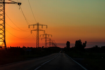 Wall Mural - Electric power pylon, electric tower at sunset