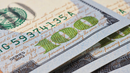 Wall Mural - american banknotes of one hundred dollars. fragment of bills close-up. new sample money. focus on th