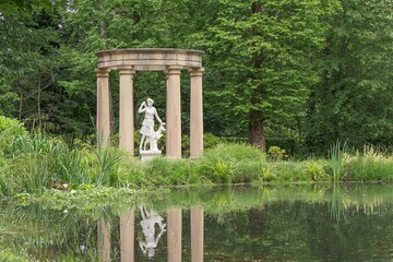 Wall Mural - Beautiful scenery of the statue of Goddess Diana in a stone temple near a pond