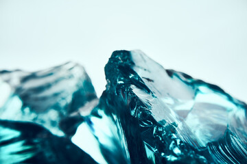 Texture of transparent blue glass on a light background.