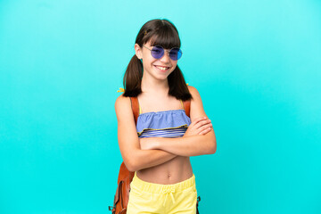 Wall Mural - Little caucasian kid going to the beach isolated on blue background keeping the arms crossed in frontal position