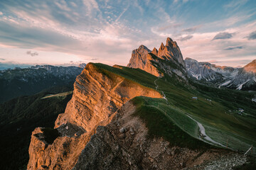 Wall Mural - Amazing views of the Dolomites mountain landscape. Sunset view from Seceda over to the Odle mountains. Spectacular dolomitean landscape, Tyrol, Italy.