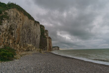 White And Brown Colored Rock Cliffs On The Alabaster Coast On A Stormy Cloudy Summer Day Near Petites-Dalles, Normandy, France