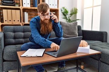 Poster - Young redhead man psychology having teleconsultation talking on the smarpthone at clinic