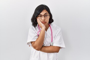 Canvas Print - Young hispanic doctor woman wearing stethoscope over isolated background thinking looking tired and bored with depression problems with crossed arms.