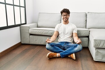 Sticker - Young hispanic man smiling confident doing yoga exercise at home