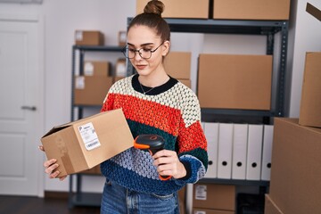 Wall Mural - Young woman ecommerce business worker scanning package at office