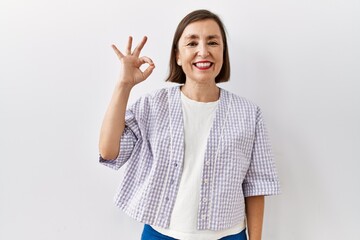 Canvas Print - Beautiful middle age hispanic woman standing over isolated background angry and mad raising fist frustrated and furious while shouting with anger. rage and aggressive concept.