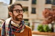Young caucasian man with beard wearing glasses outdoors on a sunny day
