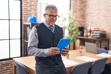 Canvas Print - Middle age grey-haired man business worker using touchpad at office