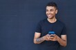 African american man smiling confident using smartphone over black background
