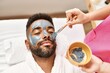 © Krakenimages.com - Man reciving facial treatment at beauty center.