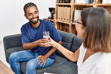 Poster - Man and woman having psychology session giving glass of water at psychology clinic