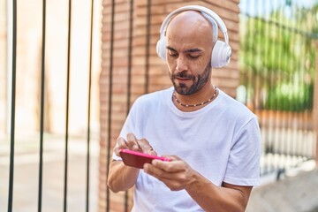 Sticker - Young bald man playing video game at street