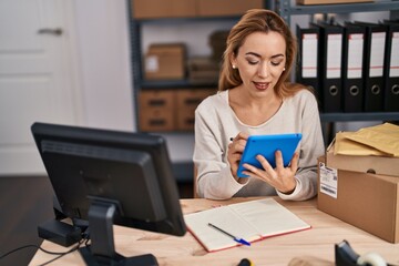 Young woman ecommerce busines worker using touchpad and computer at office