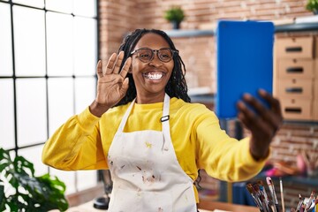 Poster - African american woman artist smiling confident having video call at art studio