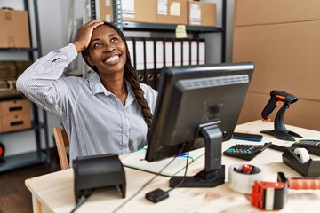 Poster - African woman working at small business ecommerce smiling confident touching hair with hand up gesture, posing attractive and fashionable