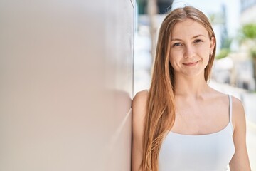 Canvas Print - Young caucasian woman smiling confident standing at street