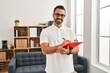 © Krakenimages.com - Young hispanic man psychologist writing on clipboard at psychology center