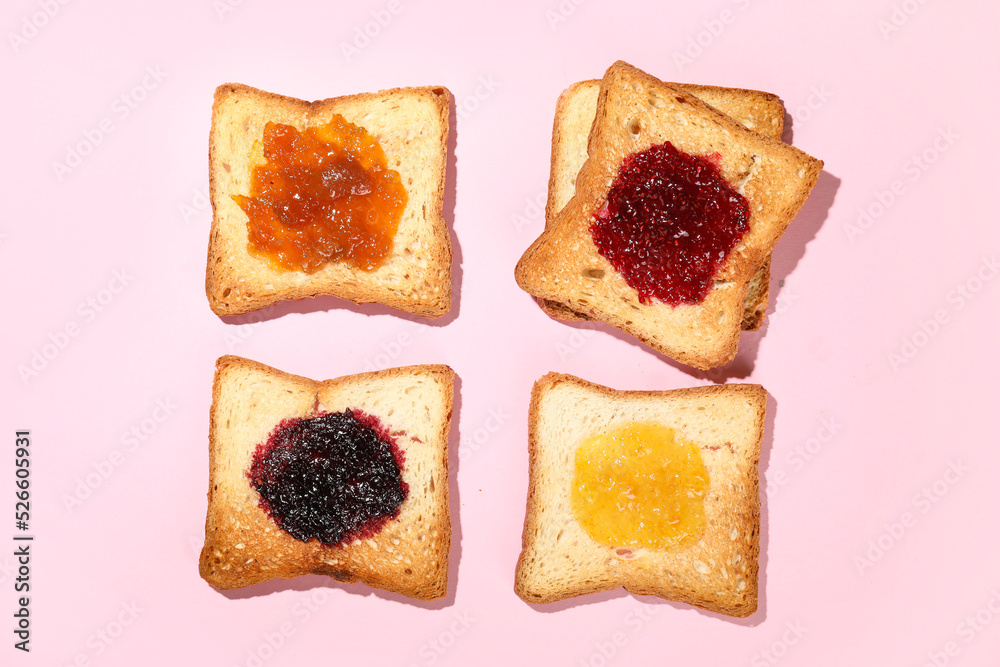 Toasts with different jams on pink background
