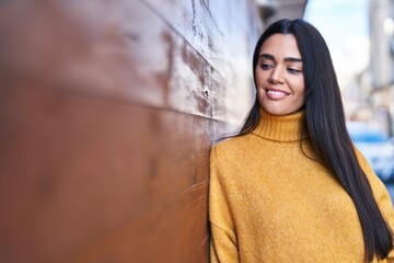 Wall Mural - Young hispanic woman smiling confident standing at street