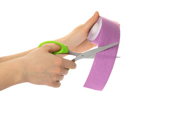 Wall Mural - Woman cutting bright kinesio tape on white background, closeup