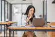 © David - Female Business Asian working on documents on laptop in the workplace, Young asian woman sitting at table doing planning financial report, business plan investment, finance analysis concept.