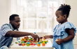 © Art_Photo - Portrait of happy love black family african american father and little girl smiling activity learn and skill brain training play with toy build wooden blocks board education game at home