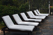 Seven deck or pool chairs for lounging and relaxing in a outdoor wooded area