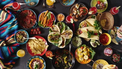 Wall Mural - Mexican family celebrates Cinco de mayo together at a festive table. Table with traditional Mexican dishes, top view
