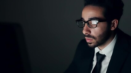 Young Arabian man using PC in dark room.