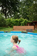© Анна Молько - A child in the water. A girl splashes in an inflatable pool in the garden on a sunny summer day. High quality photo