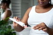 © gpointstudio - Detail of young African-American woman applying toothpaste on the wooden toothbrush