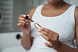 © gpointstudio - Hands of African-American woman holding eyelash mascara