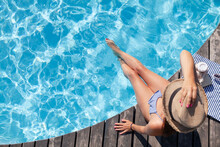 Woman On Wooden Deck Near Swimming Pool