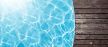 Poolside Wooden Deck And Blue Water Of Pool