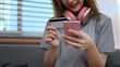 © Prathankarnpap - Cropped shot view of young woman holding credit card and purchasing product via online shopping on mobile phone