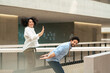 © Westend61 - Happy businesswoman giving high-five to colleague in corridor