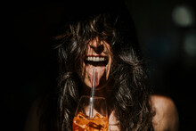 Happy Woman With Mouth Open Having Drink With Straw