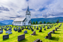 Norway, Viken, Gol, Rows Of Tombstones With Rural Church In Background