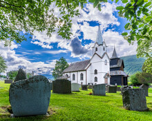 Norway, Viken, Torpo, Cemetery Tombstones With Rural Church In Background