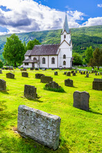Norway, Viken, Torpo, Cemetery Tombstones With Rural Church In Background