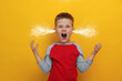 Aggressive little boy with steam coming out of his ears on orange background